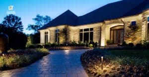 Modern backyard with low voltage landscape lighting illuminating walkway and garden.