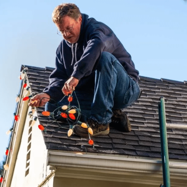 Certified lighting technician working on a holiday lighting project