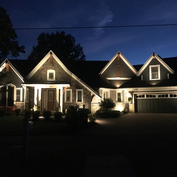 Technician preparing a landscape lighting demo for a homeowner