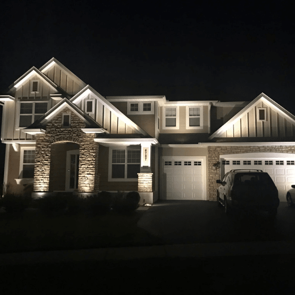 Side-by-side comparison of dim solar lights versus bright professional-grade landscape lighting