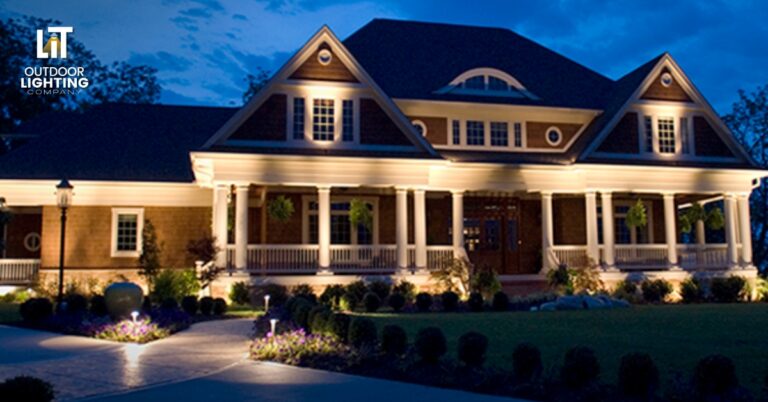 Well-lit stone walkway leading to the front door of a home